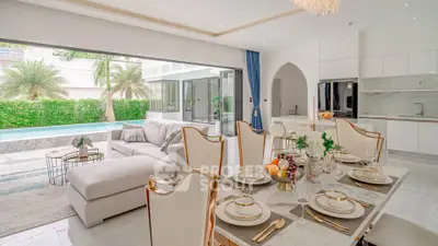 Luxurious open-plan living room with pool view and elegant dining area