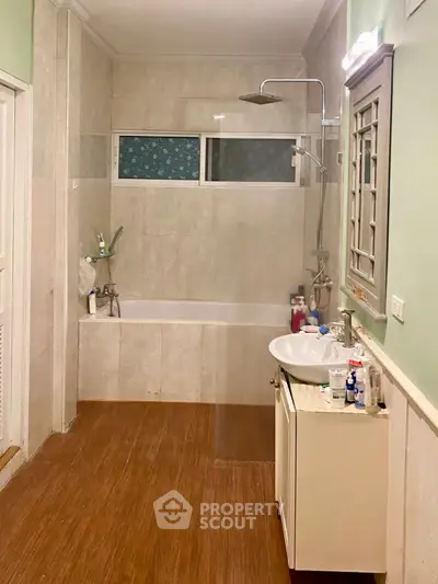 Spacious bathroom with modern fixtures and bathtub in a stylish home.