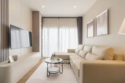 Modern living room with sleek furniture and natural light, perfect for relaxation and entertainment.