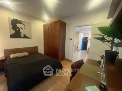 Cozy bedroom with wooden furniture and modern decor in a stylish apartment.