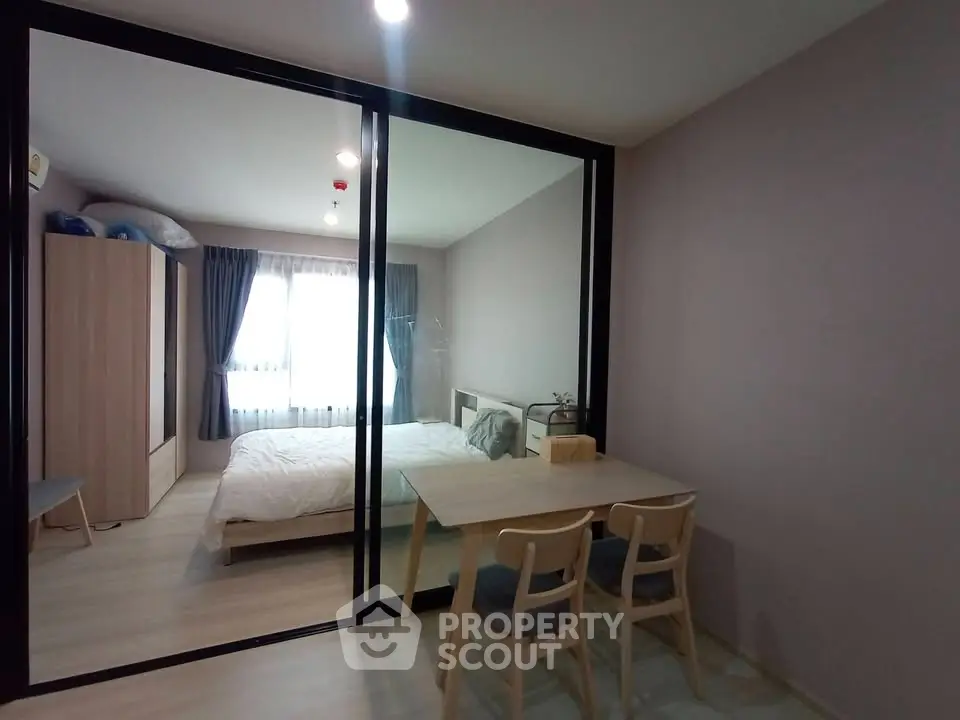 Modern bedroom with glass partition and cozy dining area