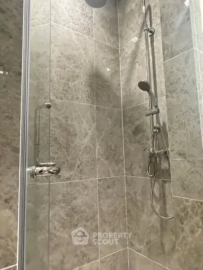Modern bathroom shower with sleek marble tiles and chrome fixtures