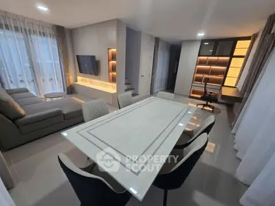 Modern living room with sleek furniture and elegant dining area