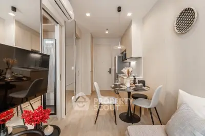 Modern living room with stylish decor and compact dining area in a cozy apartment.