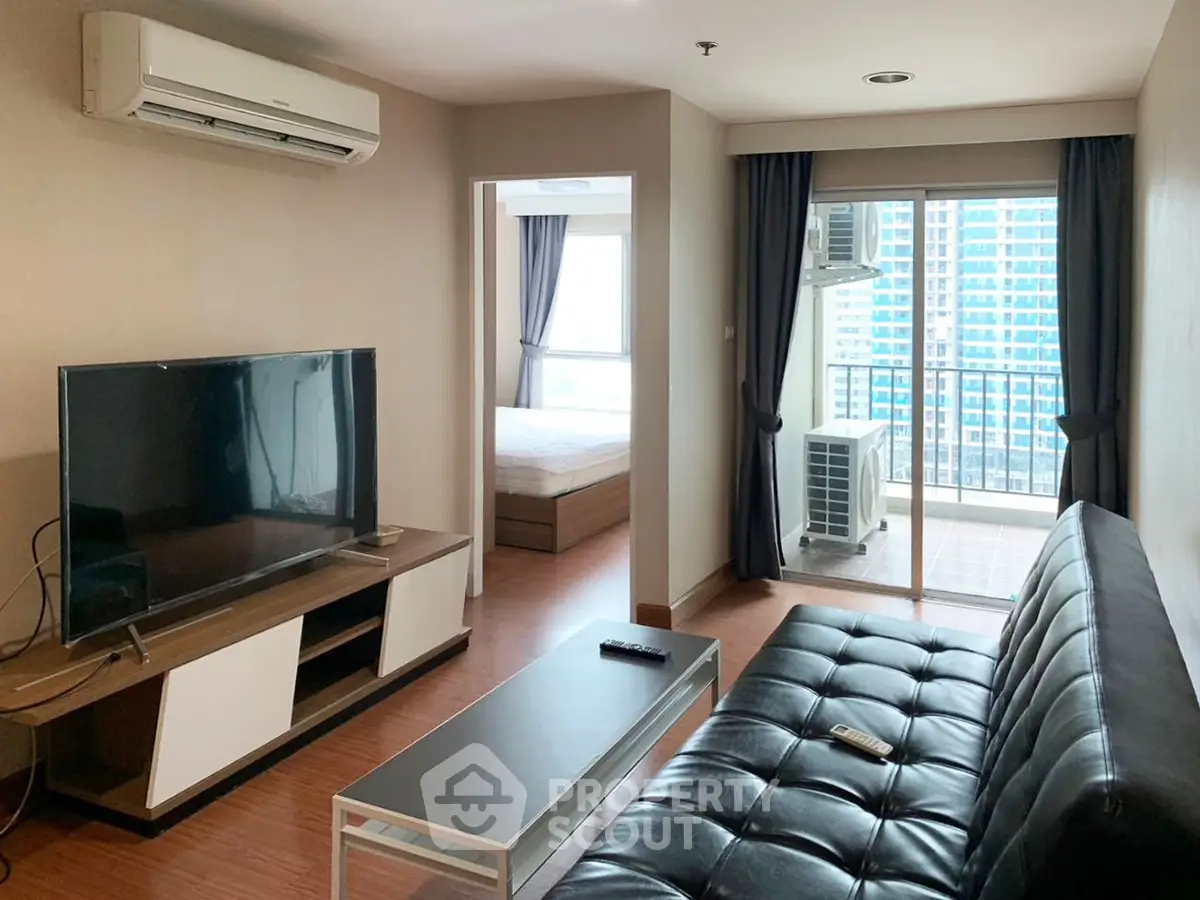 Modern living room with sleek furniture and balcony view in urban apartment