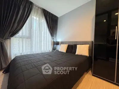 Modern bedroom with elegant black decor and large window with curtains