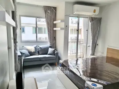 Modern bedroom with balcony, air conditioning, and stylish furnishings in a bright apartment.
