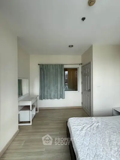 Spacious bedroom with minimalist decor and natural light