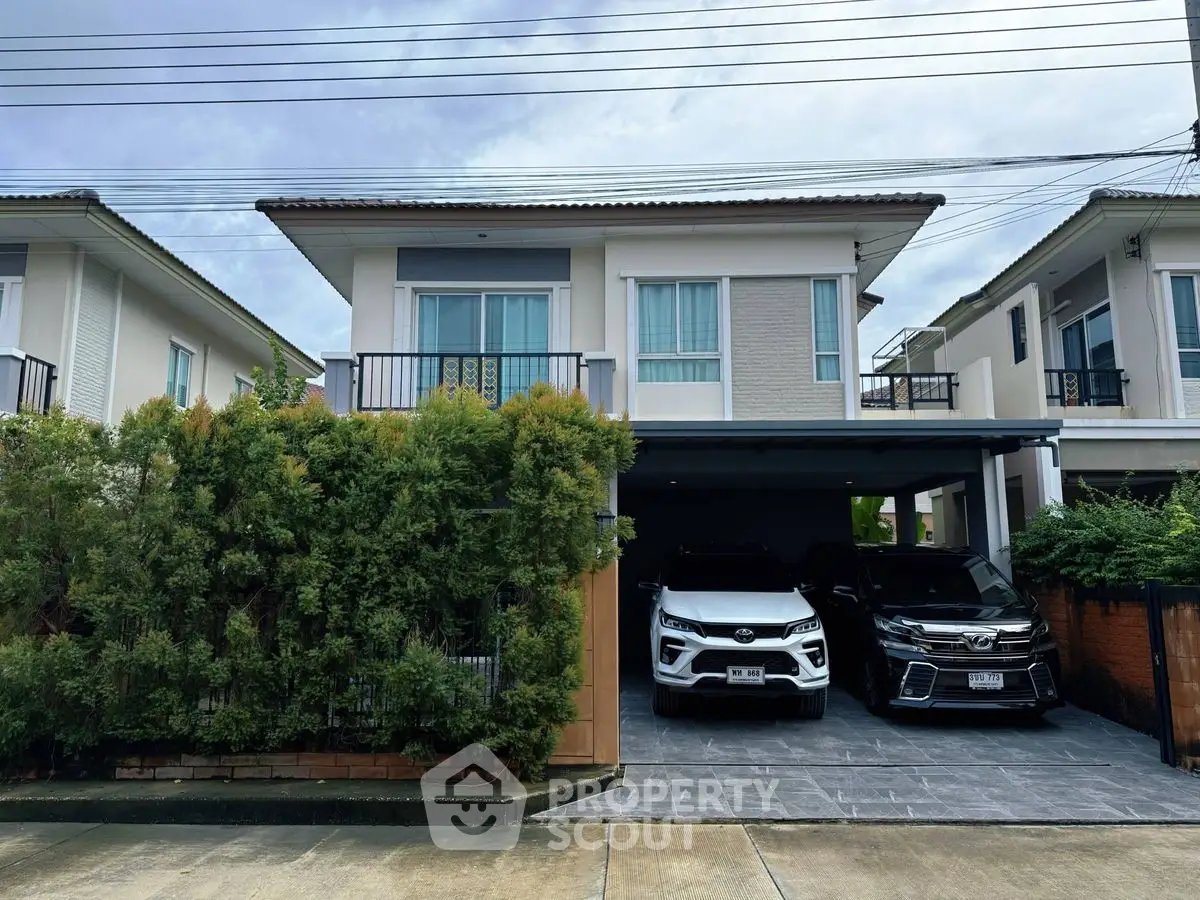 Modern two-story house with spacious driveway and lush greenery