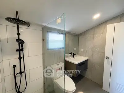 Modern bathroom with sleek fixtures and glass shower enclosure