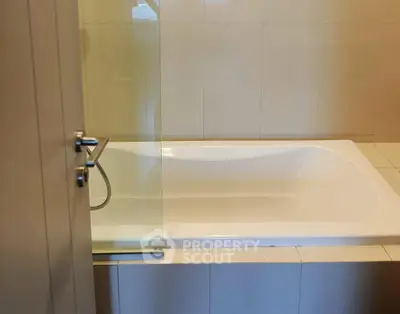 Modern bathroom with sleek bathtub and glass partition