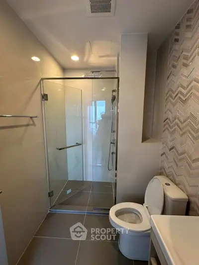 Modern bathroom with glass shower and sleek tile design