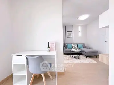 Modern living room with stylish furniture and cozy workspace, perfect for urban living.