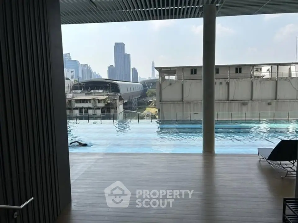 Luxurious rooftop pool with stunning city skyline view, perfect for relaxation and leisure in urban living.