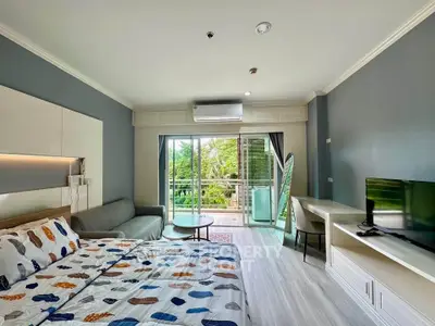 Modern bedroom with balcony view and stylish decor in a cozy apartment.