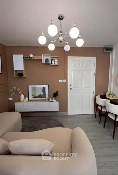 Stylish living room with modern decor and elegant lighting, perfect for cozy gatherings.