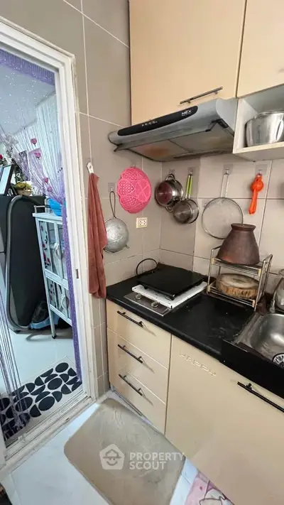 Compact kitchen with modern appliances and efficient storage solutions
