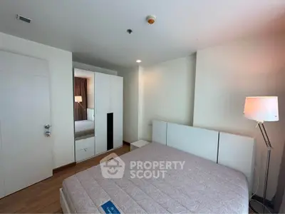 Spacious bedroom with modern furnishings and ample natural light