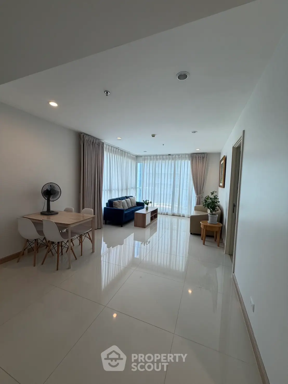 Spacious modern living room with large windows and elegant furnishings