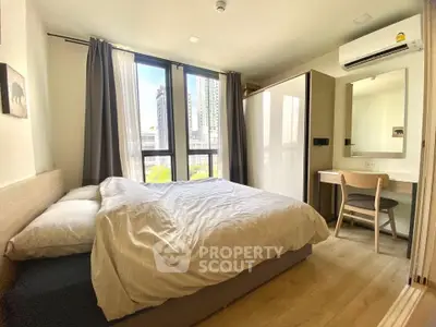 Cozy modern bedroom with large window and city view, featuring a comfortable bed and stylish furniture.