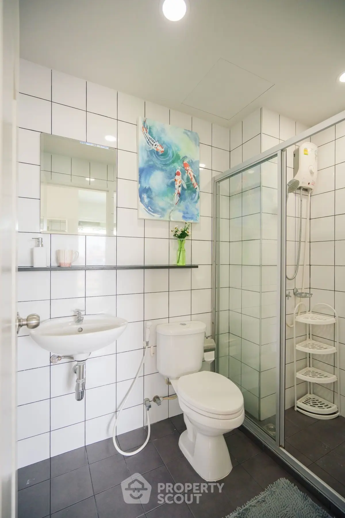 Modern bathroom with glass shower, white tiles, and contemporary fixtures.