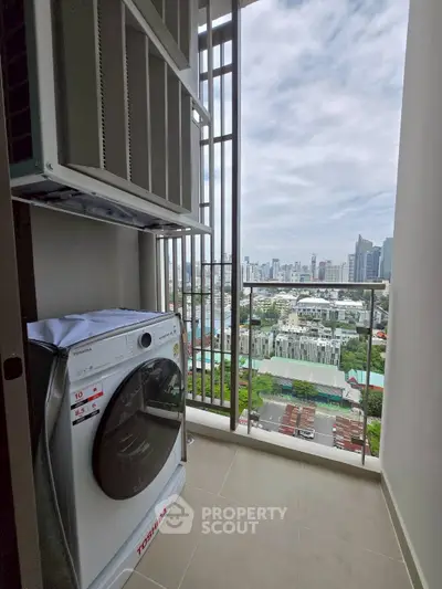 High-rise apartment balcony with city skyline view and modern washing machine.