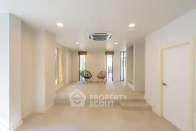 Spacious modern living room with minimalist design and large windows