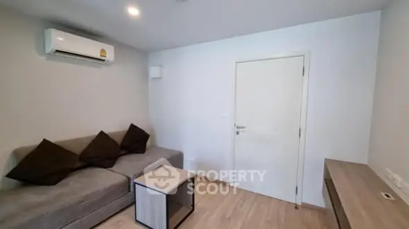 Modern living room with sleek furniture and air conditioning