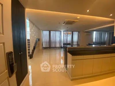 Spacious modern living room with open layout and elegant lighting, perfect for luxury living.