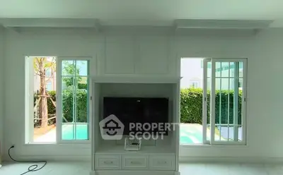 Bright living room with pool view and modern TV setup