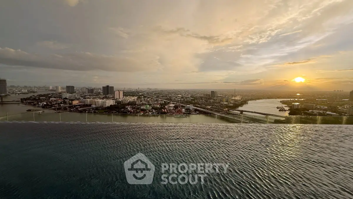 Stunning cityscape view from an infinity pool at sunset, showcasing urban skyline and river.