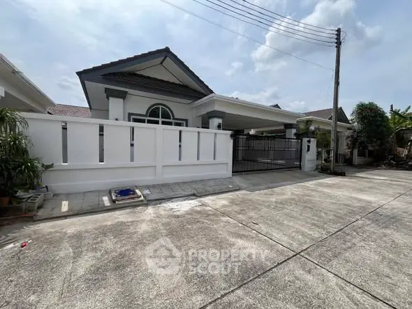 Charming single-story house with modern design and spacious driveway in a serene neighborhood.