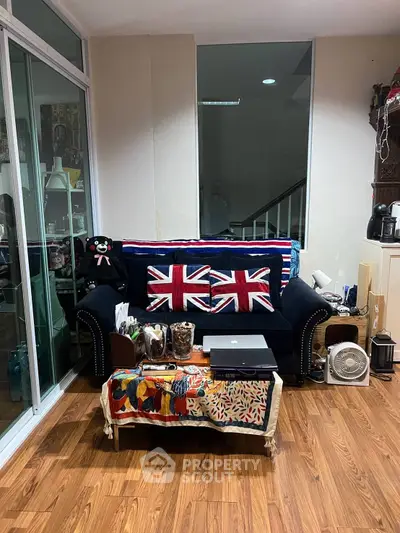 Charming living room with Union Jack themed decor and cozy seating area.