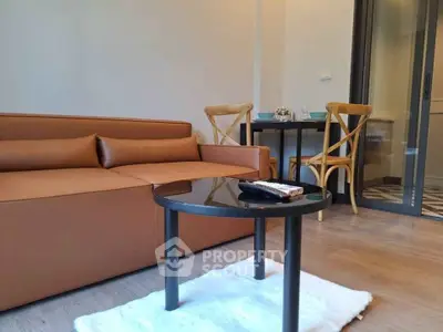 Modern living room with stylish brown sofa and elegant dining area.