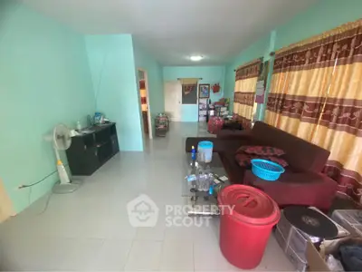Spacious living room with vibrant curtains and comfortable seating in a cozy home.