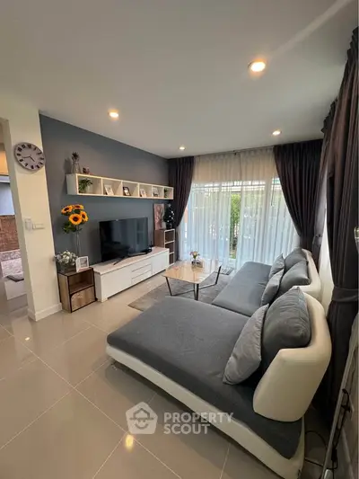 Modern living room with stylish decor and large sectional sofa, perfect for relaxation.