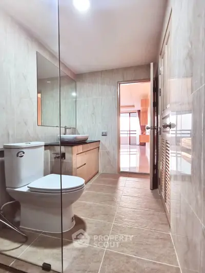 Modern bathroom with sleek design and natural light in a contemporary apartment.