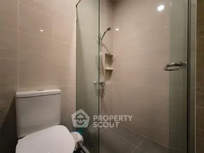 Modern bathroom with glass shower and sleek tile design