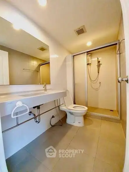 Modern bathroom with sleek fixtures and spacious shower area