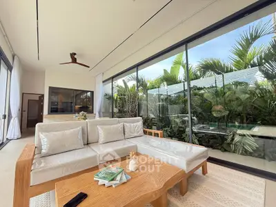 Luxurious living room with pool view and modern decor in tropical setting