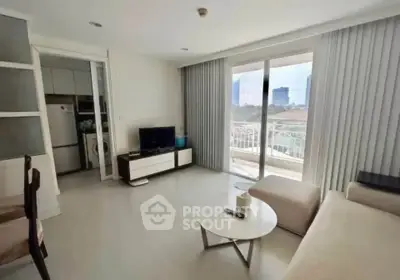 Spacious living room with modern decor and balcony view in urban apartment