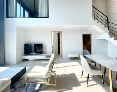 Spacious modern living room with high ceilings and elegant furniture