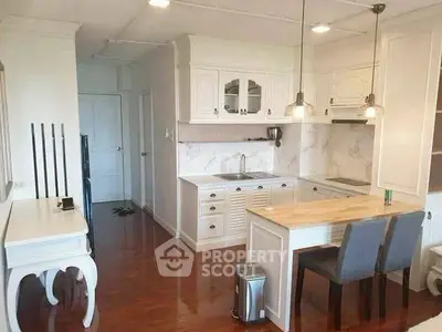 Charming kitchen with elegant white cabinetry and cozy dining area