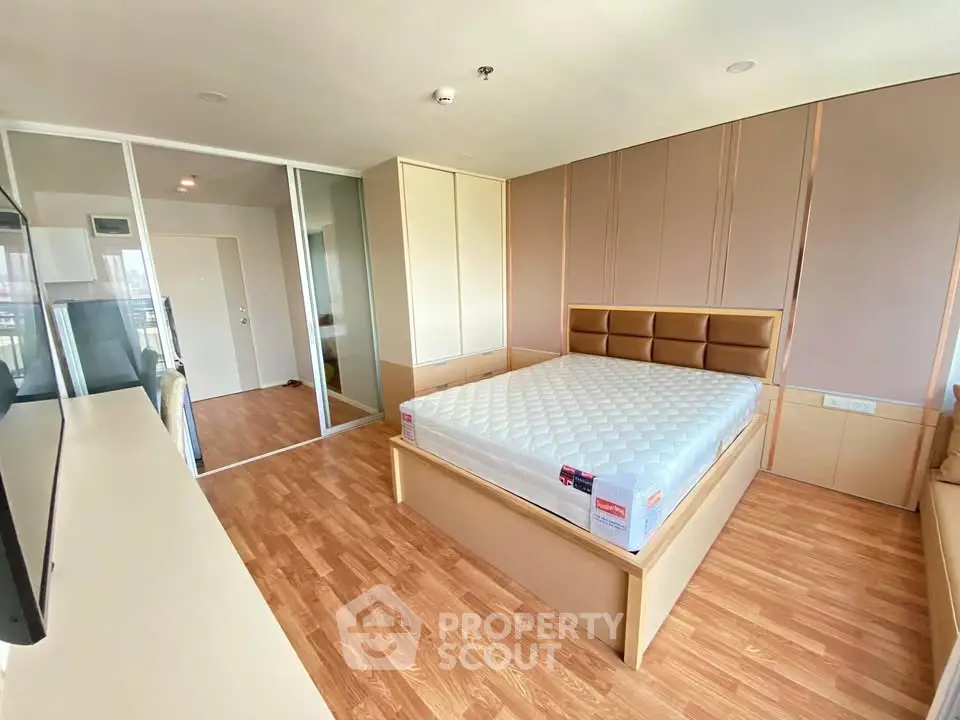 Spacious bedroom with modern design and hardwood flooring in a luxury apartment.