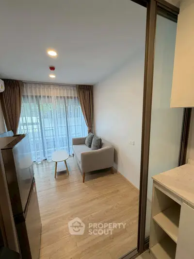 Modern living room with cozy sofa and large window in stylish apartment