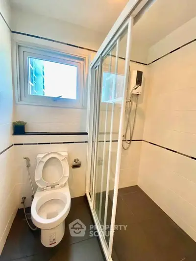 Modern bathroom with shower and toilet in sleek design