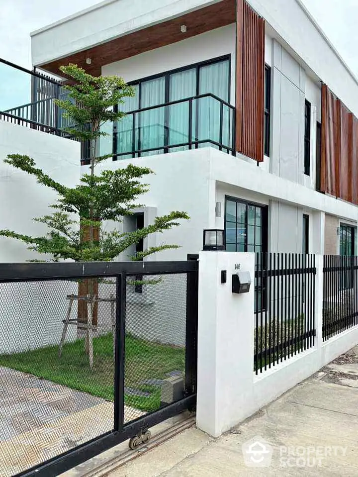 Modern two-story house with sleek design and gated entrance