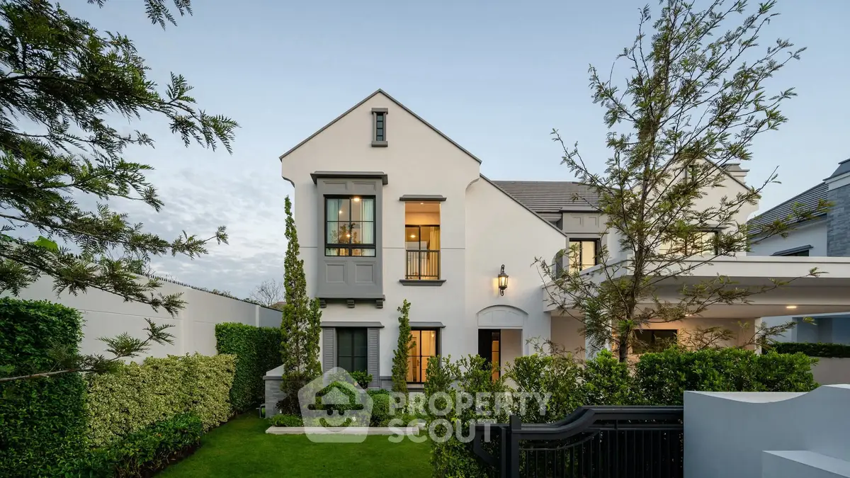 Elegant two-story house with manicured garden and modern architecture