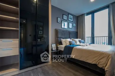 Modern bedroom with stylish decor and large windows for natural light.