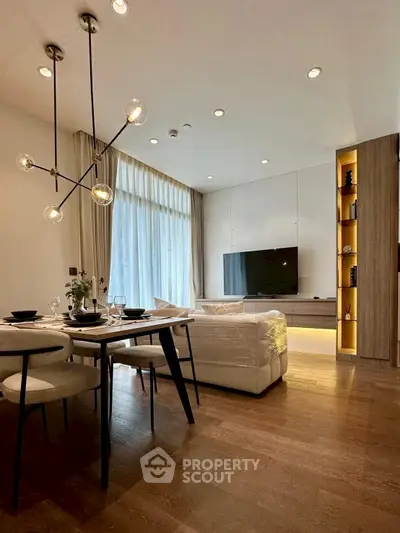 Modern living room with elegant dining area and stylish lighting